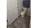 Toilet in a bathroom with gray tile flooring and neutral wall paint at 8160 Shores Edge Way, Indianapolis, IN 46237