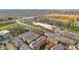 Aerial view of a neighborhood with colorful townhouses surrounded by lush trees in a charming setting at 907 Junction Pl # 41907, Indianapolis, IN 46220
