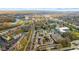 Stunning aerial showcases the vibrant neighborhood's colorful buildings, pond, and nearby river at 907 Junction Pl # 41907, Indianapolis, IN 46220
