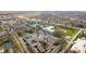 Scenic aerial view of a neighborhood with mature trees, colorful buildings, and a pond at 907 Junction Pl # 41907, Indianapolis, IN 46220