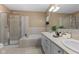 Bathroom featuring double vanity, soaking tub, shower and neutral earth tone tile at 907 Junction Pl # 41907, Indianapolis, IN 46220