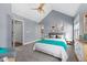 Bedroom with vaulted ceiling, ceiling fan, gray walls, carpet, and ensuite bathroom and walk-in closet at 907 Junction Pl # 41907, Indianapolis, IN 46220
