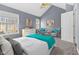 Bedroom featuring large windows, a ceiling fan, grey walls, and two sitting chairs with throw pillows at 907 Junction Pl # 41907, Indianapolis, IN 46220