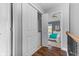 Bright hallway with hardwood floors leading to a bedroom with a ceiling fan and large closet at 907 Junction Pl # 41907, Indianapolis, IN 46220