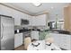 Kitchen boasts stainless steel appliances, white cabinets, granite countertops, and eat-in area at 907 Junction Pl # 41907, Indianapolis, IN 46220