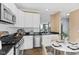 Kitchen features granite countertops, stainless steel appliances, and view to Gathering room at 907 Junction Pl # 41907, Indianapolis, IN 46220