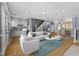 Open concept living area features hardwood floors, tons of light, and an adjacent kitchen at 907 Junction Pl # 41907, Indianapolis, IN 46220