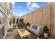 Private outdoor patio features a cozy seating area, dining table, and tall fence at 907 Junction Pl # 41907, Indianapolis, IN 46220