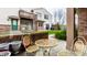 Cozy backyard patio with comfortable seating, perfect for relaxing outdoors with a brick wall at 9449 Maple Way, Indianapolis, IN 46268
