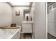 Bathroom featuring a gray walls, modern vanity, soaking tub with wood caddy, and gray vinyl flooring at 9449 Maple Way, Indianapolis, IN 46268