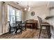 Dining room boasts warm lighting, black dining set, a piano and a bar area with additional seating at 9449 Maple Way, Indianapolis, IN 46268