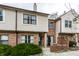 Attractive townhome featuring a brick facade, vinyl siding, and a cozy front patio at 9449 Maple Way, Indianapolis, IN 46268