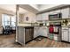 Open concept kitchen featuring granite countertops, stainless steel appliances, light-gray cabinets and wooden floors at 9449 Maple Way, Indianapolis, IN 46268
