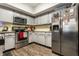 Well-lit kitchen features gray cabinets, stainless steel appliances, granite countertops and wooden floors at 9449 Maple Way, Indianapolis, IN 46268
