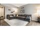 Comfortable living room featuring a large sectional sofa, light-colored rug, and modern decor at 9449 Maple Way, Indianapolis, IN 46268