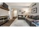 Spacious living area featuring a cozy fireplace, sectional sofa, and open layout at 9449 Maple Way, Indianapolis, IN 46268