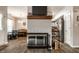 Open-concept living area with a modern fireplace, dining area, and a glimpse of the kitchen at 9449 Maple Way, Indianapolis, IN 46268