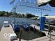 Modern boat lift on a peaceful lake, offering convenient storage and protection for your watercraft with a beautiful backdrop at 102 Clarendon Dr # 514, Noblesville, IN 46062