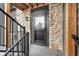 Apartment front door entrance with stone siding and black metal stair railings at 102 Clarendon Dr # 514, Noblesville, IN 46062