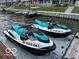 Two teal and white jet skis docked at lakeside condos at 102 Clarendon Dr # 514, Noblesville, IN 46062