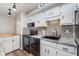 Modern kitchen with black appliances, granite countertops, and a stylish tile backsplash at 102 Clarendon Dr # 514, Noblesville, IN 46062