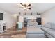 Cozy living room area with ceiling fan, wood flooring, and open kitchen area at 102 Clarendon Dr # 514, Noblesville, IN 46062