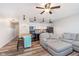Cozy living room area with ceiling fan, wood flooring, and open kitchen area at 102 Clarendon Dr # 514, Noblesville, IN 46062