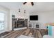 Bright living room boasts a stone fireplace, TV, and a door to the patio at 102 Clarendon Dr # 514, Noblesville, IN 46062