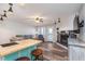 Open-concept living room with bar seating, fireplace, and sliding door to balcony at 102 Clarendon Dr # 514, Noblesville, IN 46062