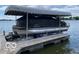 Waterfront covered pontoon boat with lift, ready for lake adventures at 102 Clarendon Dr # 514, Noblesville, IN 46062