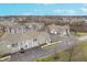 An aerial view showcases the townhouse community with manicured lawns and paved driveways at 1160 Falcon Rdg, Carmel, IN 46280