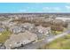 Scenic aerial view of a sprawling townhouse community near a tranquil lake and lush greenery at 1160 Falcon Rdg, Carmel, IN 46280