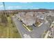 An aerial view showcases the townhouse community with manicured lawns and paved driveways at 1160 Falcon Rdg, Carmel, IN 46280