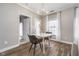 Bright dining area with modern chandelier, wood floors, and view to front patio at 1160 Falcon Rdg, Carmel, IN 46280