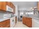 Open kitchen with stainless steel sink overlooking the dining and living areas at 1160 Falcon Rdg, Carmel, IN 46280