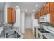 Functional kitchen with wood cabinetry, white appliances, and ample counter space at 1160 Falcon Rdg, Carmel, IN 46280