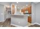 Spacious kitchen featuring breakfast bar, wood cabinets, and modern appliances at 1160 Falcon Rdg, Carmel, IN 46280