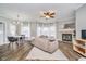 Bright living room with hardwood floors, fireplace, neutral walls, and modern furnishings at 1160 Falcon Rdg, Carmel, IN 46280