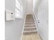 Inviting staircase with neutral carpet, white trim, and a nearby window for natural light at 1160 Falcon Rdg, Carmel, IN 46280