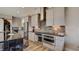 An open-concept kitchen with a dark island, stainless steel appliances, and a tile backsplash at 13395 Vickery Ridge Dr, Fishers, IN 46037
