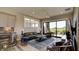 Contemporary living room with comfortable leather furniture and access to outdoor patio at 13395 Vickery Ridge Dr, Fishers, IN 46037