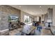 Open-concept living room flows into a modern kitchen, featuring a stylish brick accent wall and lots of natural light at 13395 Vickery Ridge Dr, Fishers, IN 46037