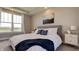 Inviting main bedroom offers a large window, tray ceiling, plush carpet, and well-placed bedside tables at 13395 Vickery Ridge Dr, Fishers, IN 46037