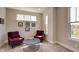 Comfortable sitting room with two chairs, a coffee table, and natural light from multiple windows at 13395 Vickery Ridge Dr, Fishers, IN 46037
