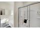 Modern bathroom featuring a glass-enclosed shower, tub, and sleek cabinetry, perfect for comfort at 1347 Shaw Ln, Shelbyville, IN 46176