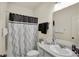 Bright bathroom featuring a shower with decorative curtain and sink with white counter-top at 1347 Shaw Ln, Shelbyville, IN 46176