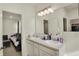 Bright bathroom with a double sink vanity, spacious counter, and easy access to the bedroom at 1347 Shaw Ln, Shelbyville, IN 46176