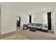 Open-concept bedroom with carpet floors, comfortable seating, and large window at 1347 Shaw Ln, Shelbyville, IN 46176