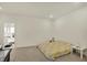 Well-lit bedroom showcasing neutral tones, carpet, and easy access to an en-suite bathroom at 1347 Shaw Ln, Shelbyville, IN 46176