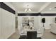 Bright dining room with a marble table, white chairs, and contemporary lighting at 1347 Shaw Ln, Shelbyville, IN 46176